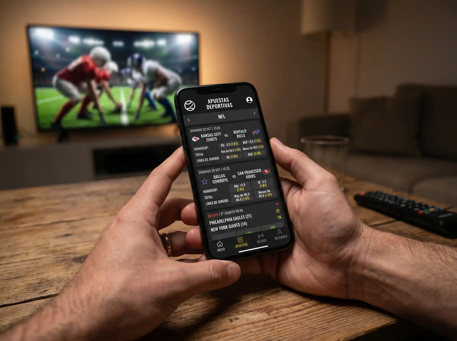 Smartphone mostrando aplicación de apuestas NFL con cuotas live durante un partido